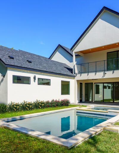 Modern two-story home with a small swimming pool in the backyard.