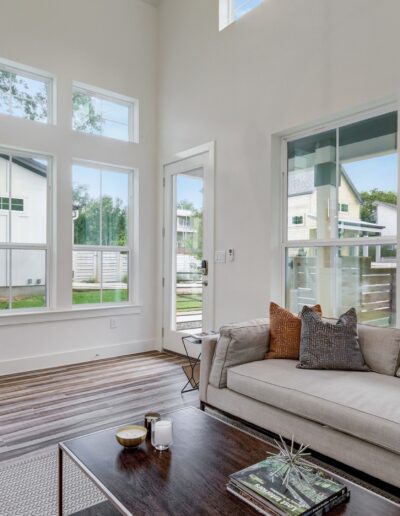 Modern living room with large windows and natural light.