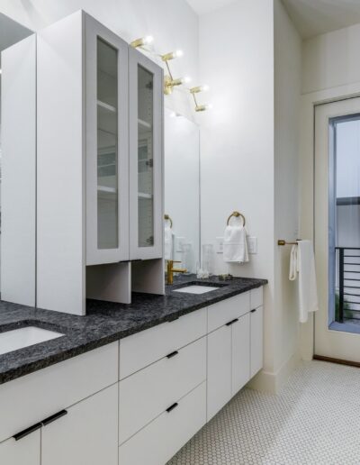 Modern bathroom interior with double vanity and walk-in shower.